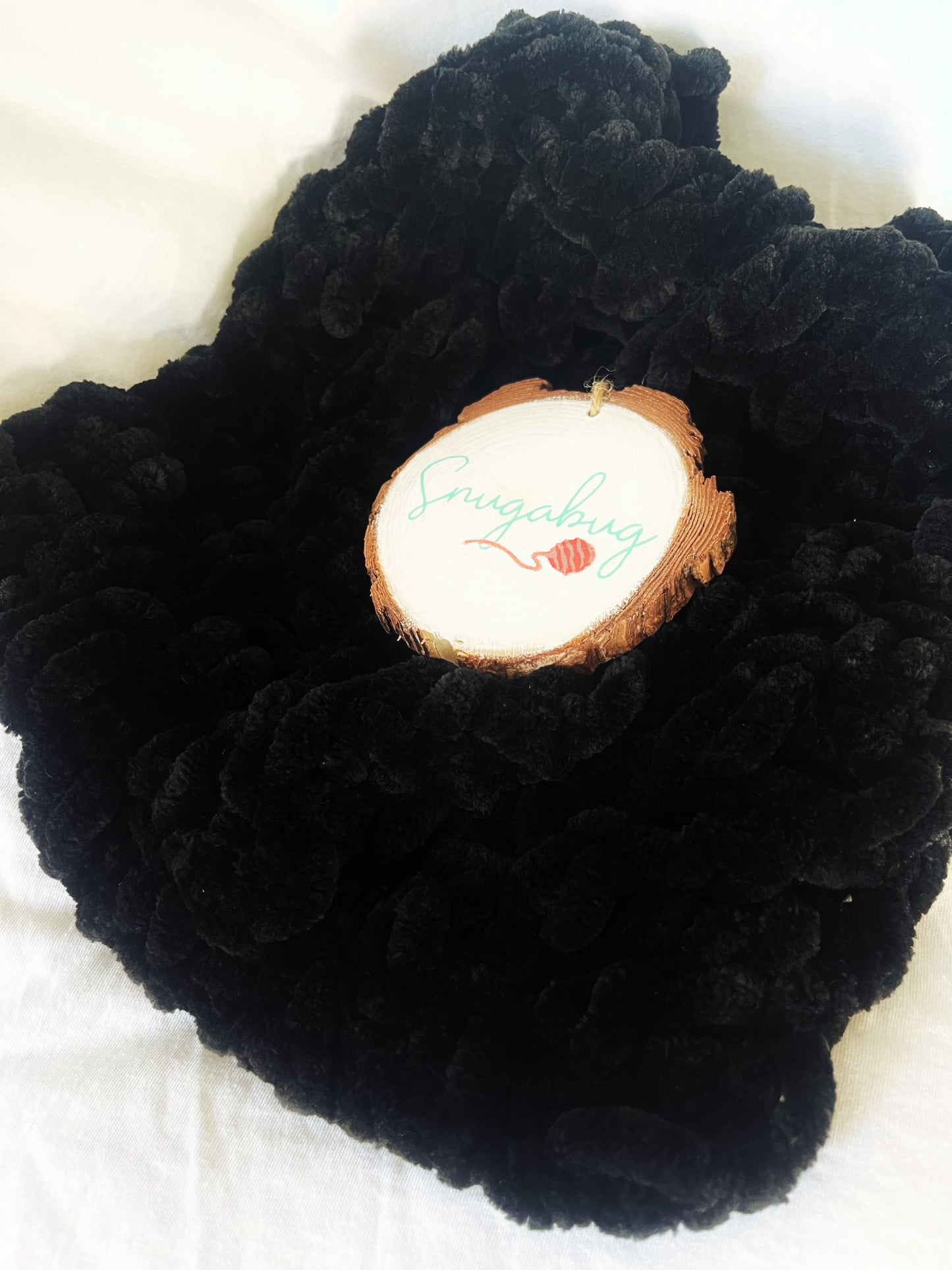 Bold jet black chenille toddler blanket, hand-knitted with chunky yarn for a modern look—great for stylish nursery or toddler room decor.