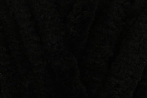 Close-up of soft jet black chenille yarn texture used in hand-knitted baby comforters by SnugaBug