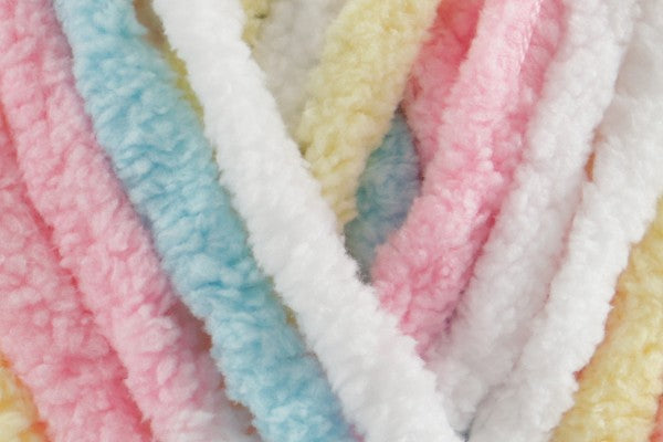 Close-up of ultra-soft chenille yarn in pastel rainbow tones of pink, blue yellow and white – Rainbow Dreams Snuggle Square baby comforter by SnugaBug