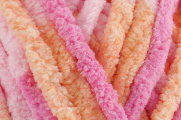 Close-up of ultra-soft chenille yarn in peachy orange and pink tones – Tutti Fruitti Snuggle Square baby comforter by SnugaBug