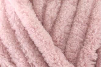Close-up of soft dusky pink chenille yarn texture used in hand-knitted baby comforters by SnugaBug