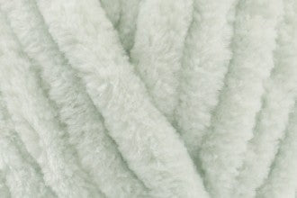 Close-up of soft pale mint green chenille yarn texture used in hand-knitted baby comforters by SnugaBug